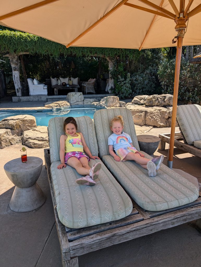 Kids lying by the pool at safari lodge